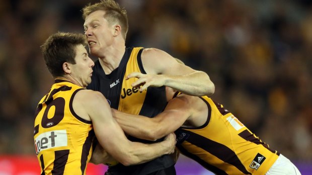 Jack Riewoldt of the Tigers is locked up by Liam Shiels and Will Langford of the Hawks.