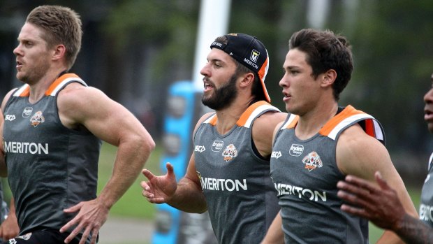 Gearing up for the season ahead: James Tedesco, centre, goes through his paces at Wests Tigers training at Concord on Monday.