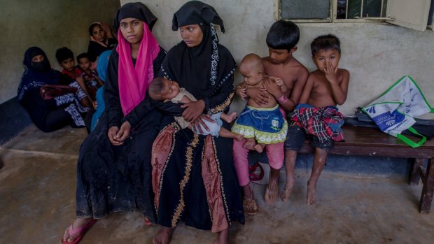 Rohingya women and children wait for treatment at a health complex run in a refugee camp in Bangladesh.