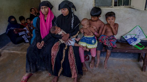 Rohingya women and children wait for treatment at a health complex run in a refugee camp in Bangladesh.