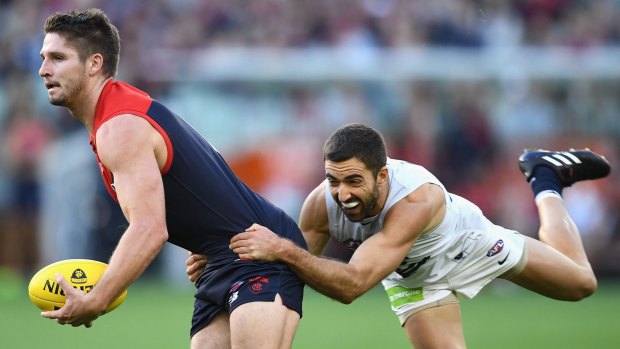 Good grab: Melbourne's Jesse Hogan shrugs a tackle from Carlton's Kade Simpson.