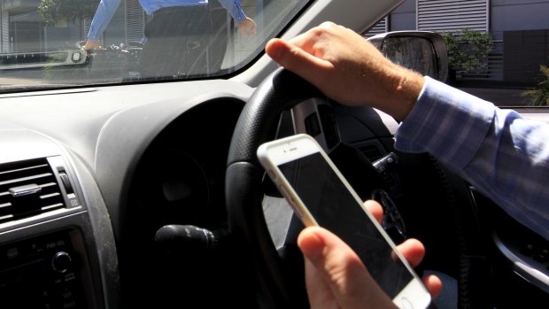 Drivers face $400 fines and 3 demerits if caught using their phones like this behind the wheel.