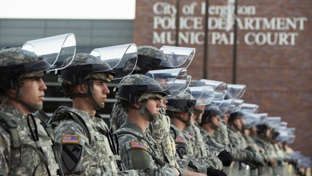 National Guard soldiers stand in formation outside Ferguson's police department.