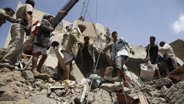 People search for survivors amid the rubble of houses destroyed by Saudi-led airstrike in Sanaa, Yemen on Monday.