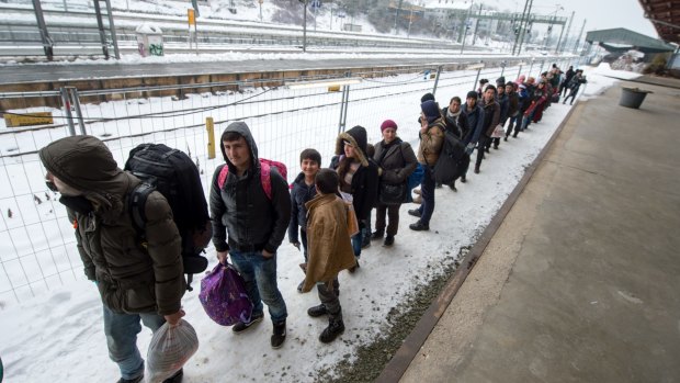 Refugees walk to a chartered train at the railway station of Passau, Germany on Tuesday. Migrants and refugees continue to arrive in Germany to seek for asylum. 
