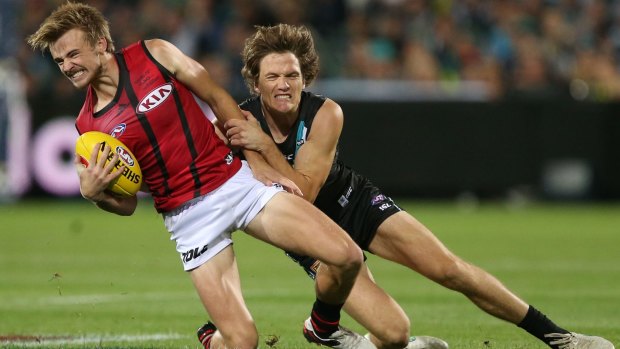 Martin Gleeson of the Bombers is tackled by Jared Polec of the Power.