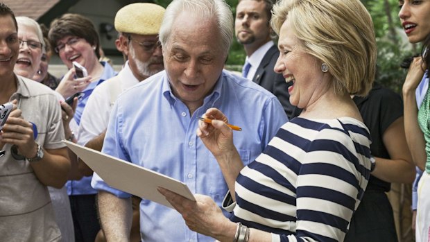 Democratic US presidential candidate Hillary Clinton signs autographs after she spoke at the home of Sean and Vidyha Bagniewski in the Beaverdale area of Des Moines, Iowa.