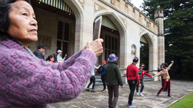 Chinese tourists enjoy a dance during an open day at Government House in Sydney.