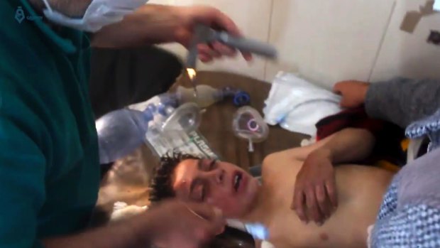 A Syrian doctor treats a boy following a suspected chemical attack in the town of Khan Sheikhoun.