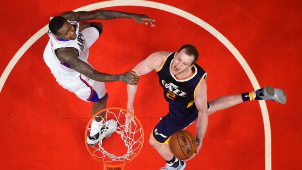 Utah Jazz forward Joe Ingles (right) shoots as Los Angeles Clippers forward Luc Richard Mbah a Moute defends.