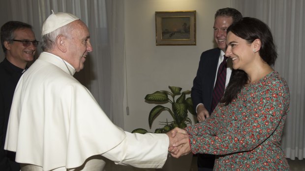 The Pope greets Paloma Garcia Ovejero, Burke's deputy, the first woman to hold the post. 
