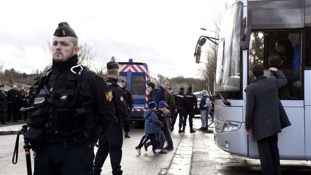 French gendarmes stand by as children are evacuted from a school in Dammartin-en-Goele, north-east of Paris.
