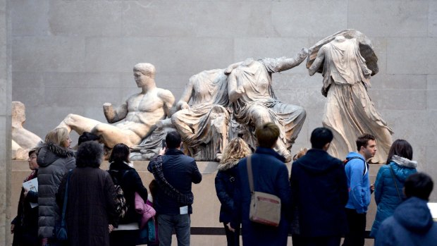 Visitors look at the Parthenon Marbles, also known as the Elgin Marbles, in the British Museum in London.