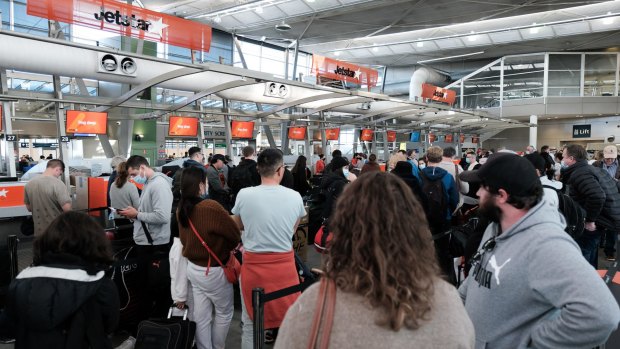 Travellers heading overseas for the July holidays may face long waits, similar to the June long weekend queues (pictured).