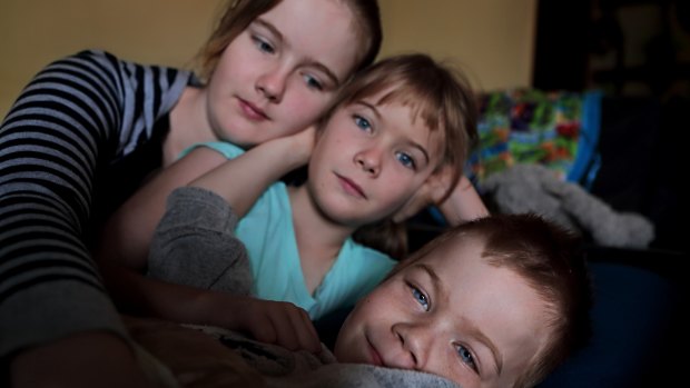 Oshin with his sisters Amitiel (12) and Shilah (8), who are confused and frightened by their brother's situation. 