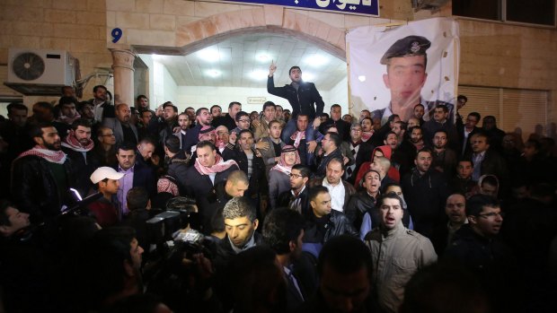 Supporters and family members of Jordanian pilot Muath al-Kasasbeh gather following his reported killing.