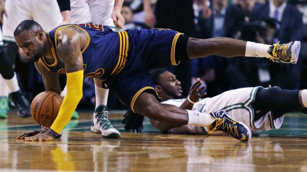 Cleveland Cavaliers forward LeBron James hits the floor after colliding with Boston Celtics forward Jae Crowder.
