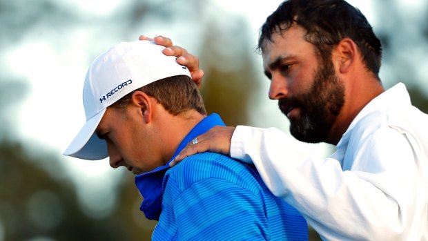 Jordan Spieth (left) and caddie Michael Greller react after finishing on the 18th green during the final round of the US Masters.
