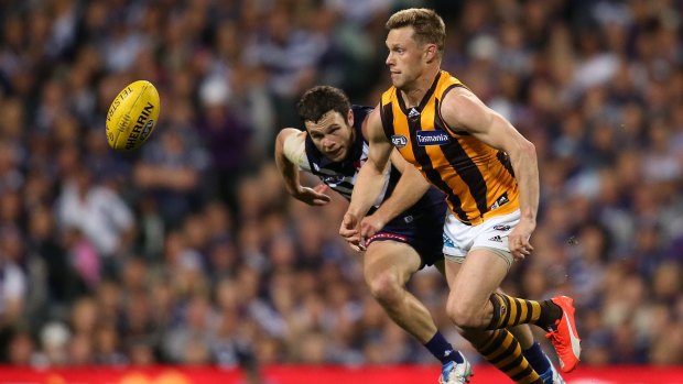 Hawk Sam Mitchell leads Freo's Hayden Ballantyne to the ball in the opening term.