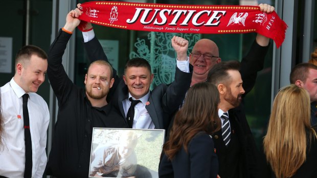 Relatives of the Hillsborough victims celebrate as they depart Birchwood Park after hearing the conclusions of the Hillsborough inquest.