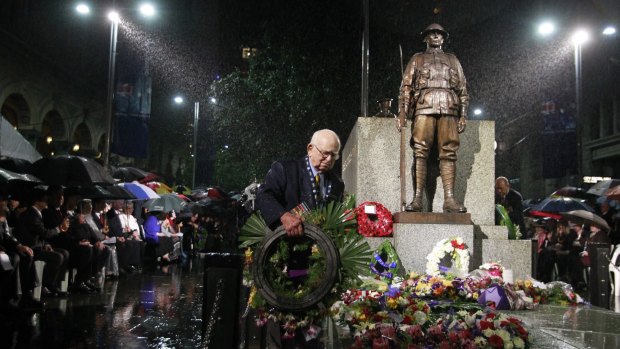 Wal Scott-Smith endures the heavy rain at the  Anzac Day Dawn Service at Martin Place in 2011.