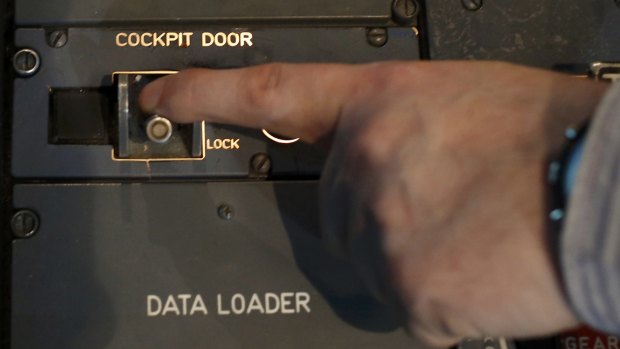 Sealed in: A person moves the switch of the cockpit door locking system inside a flight simulator of an Airbus A320 in Vienna. 