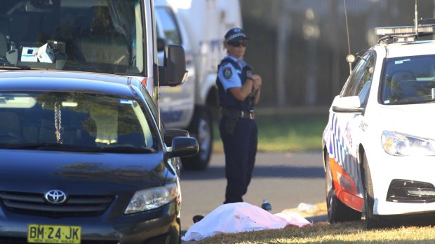 A police officer at the scene of the Ingleburn shooting, guarding what appeared to be a body.
