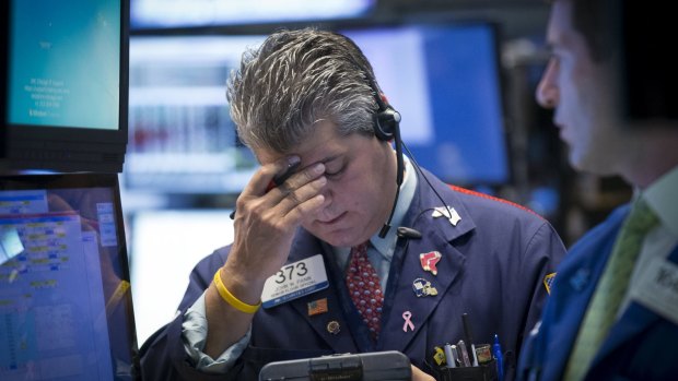 Worried traders work on the floor of the New York Stock Exchange. The Dow Jones industrial average lost more than a 1000 points on Monday morning.