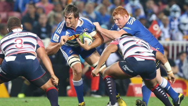 Eben Etzebeth of the Stormers braces for the impact as he comes up against the Rebels defence.