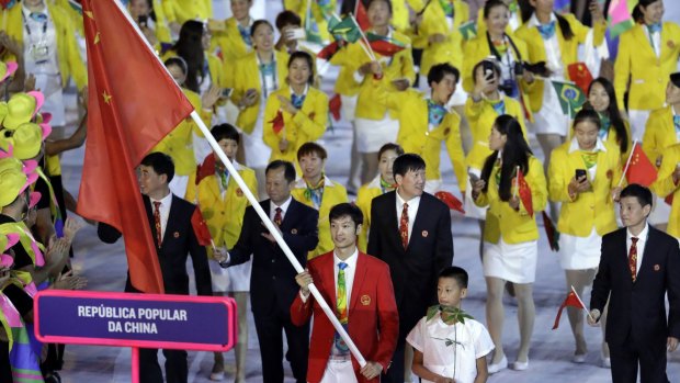 Lei Sheng carries the flag of China during the opening ceremony.