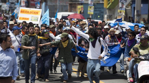 National University students march to the National Palace to take part in a strike calling for the resignation of Guatemalan President Otto Perez Molina, in Guatemala City on August 27.