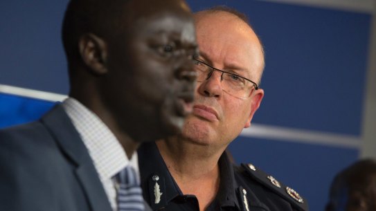 Police Commisioner Graham Ashton listens to African community leader Kot Monoah at a press conference on Wednesday.