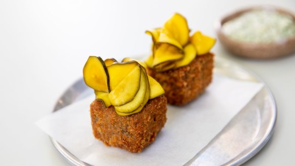 Crumbed and fried pig's head terrine topped with zucchini pickles.