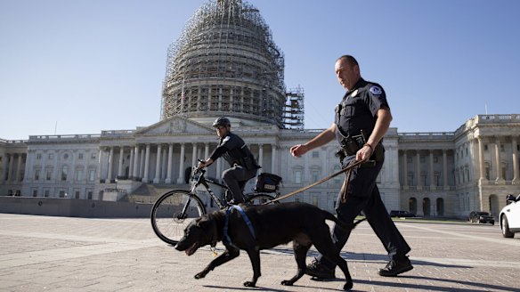 US Capitol Police officers keep watch over the East Front of the Capitol after a fresh threat from Islamic State.
