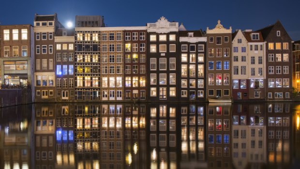 A row of disinctive, traditional canalhouses, Amsterdam.