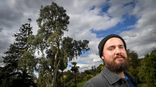 Ryan Prehn and the remnant river red gum, which could be up to 300 years old, according to the Royal Botanic Gardens.