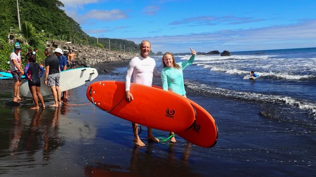 Kristen Pankratz, right, and her father David pose ahead of a surf in Tahiti.