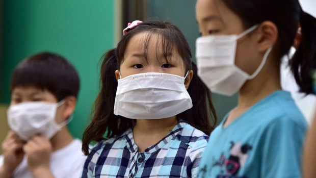 Students wear face masks during a special class on MERS virus at a school in Seoul on Wednesday.