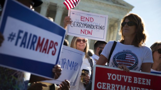 People demonstrate outside the US Supreme Court as justices heard arguments in a previous key gerrymandering case, in October.