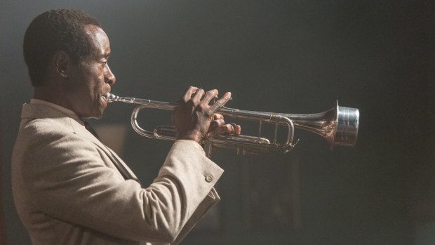To prepare for his role as Miles Davis, Don Cheadle (above in <i>Miles Ahead</i>) learned to play the trumpet with help from Wynton Marsalis, an old friend. 
