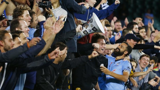 Fan favourite: Sydney FC's Alex Brosque celebrates with fans on Friday night.