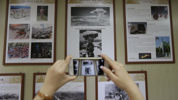 Pictures of Hiroshima and Nagasaki atomic bombings on display.