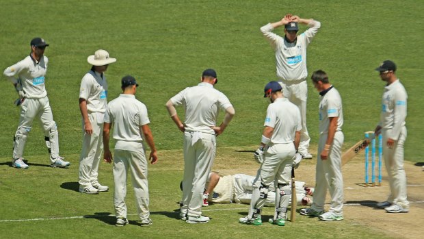 Down for the count: Ben Rohrer lies on the MCG turf after being struck in the head.