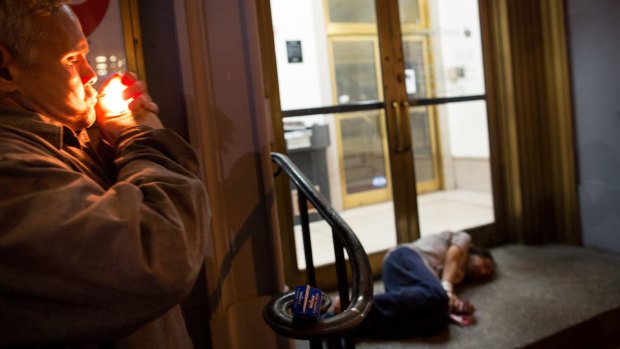 Charles Medina, lighting up at left, is a homeless man in New York who has used a synthetic drug known as K2.