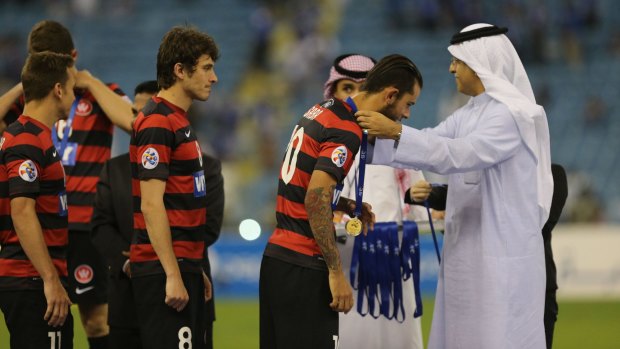 Western Sydney Wanderers players receive their medals after the game.