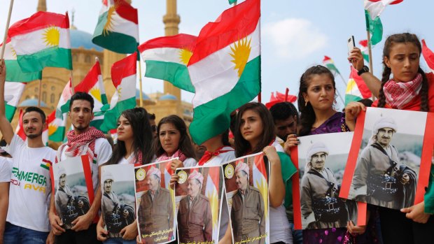 Kurds hold pictures of Iraqi Kurdish leader Masoud Barzani and his father Mustafa during an independence rally.
