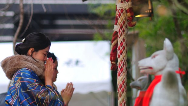 Women praying at the Chanoki Shrine, on the Seven Gods of the Good Fortune walk.