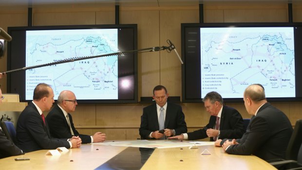 Public secrets: Tony Abbott is filmed receiving a briefing from ASIO Director-General Duncan Lewis.