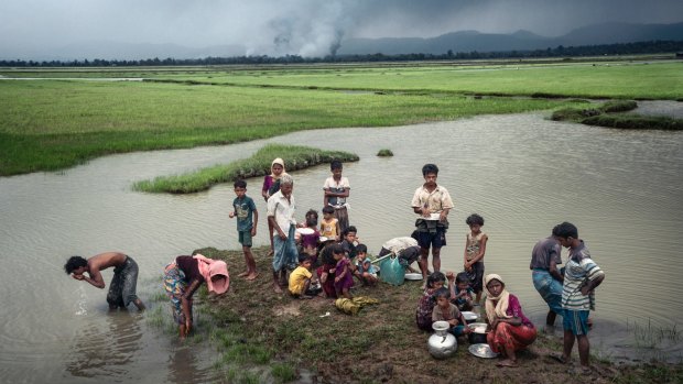 Rohingya refugees rest near the Naf River separating Myanmar and Bangladesh after crossing the border this month.