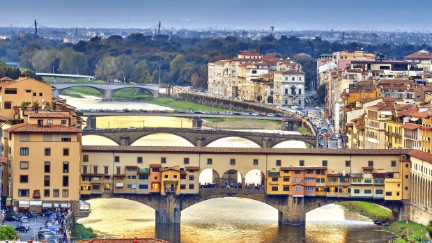 Bridges over the Arno River at sunset in Florence, Italy.